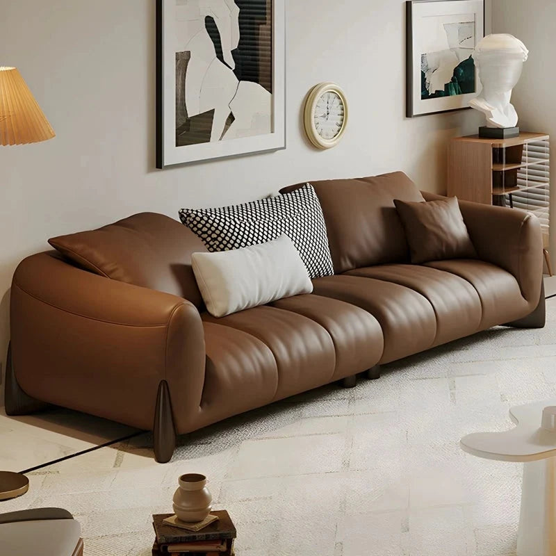 warm brown sofa with deep cushions, soft back support and wide comfortable arms — front view in a bright living room
