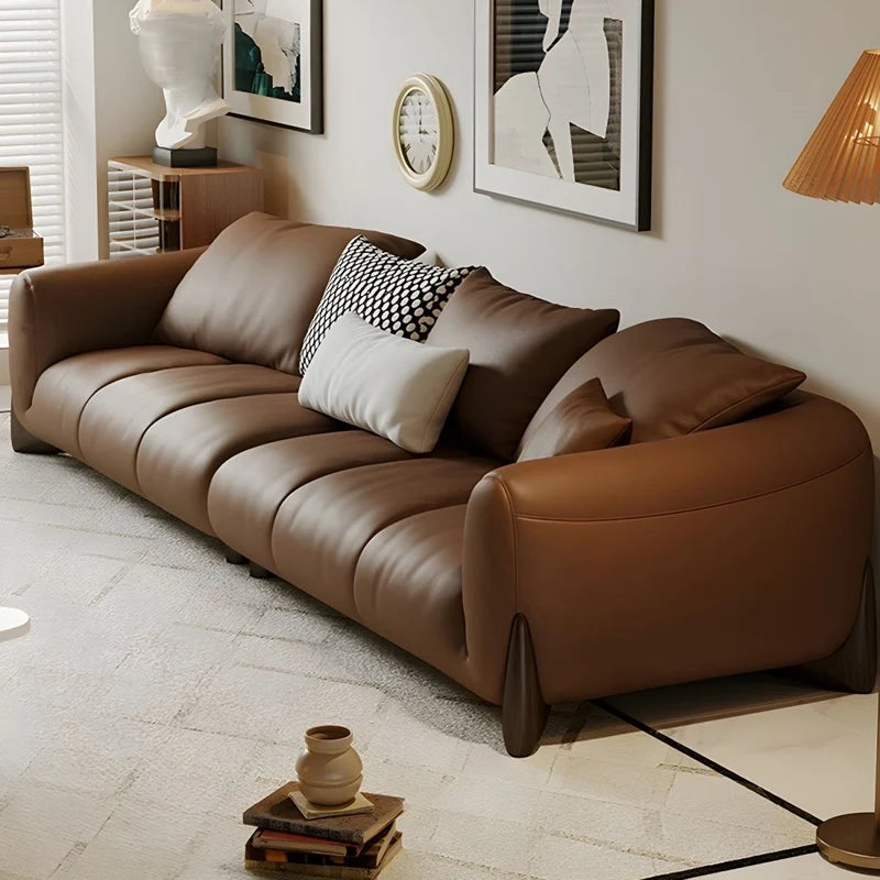 warm brown sofa with deep cushions, soft back support and wide comfortable arms — angled view showing the full shape and c...