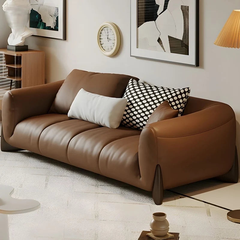 warm brown sofa with deep cushions, soft back support and wide comfortable arms — close view showing the cushion and surfa...