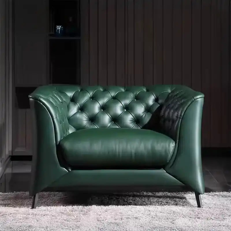 classic dark faux leather sofa with deep button details, high back and broad supportive arms — wide room view showing the...