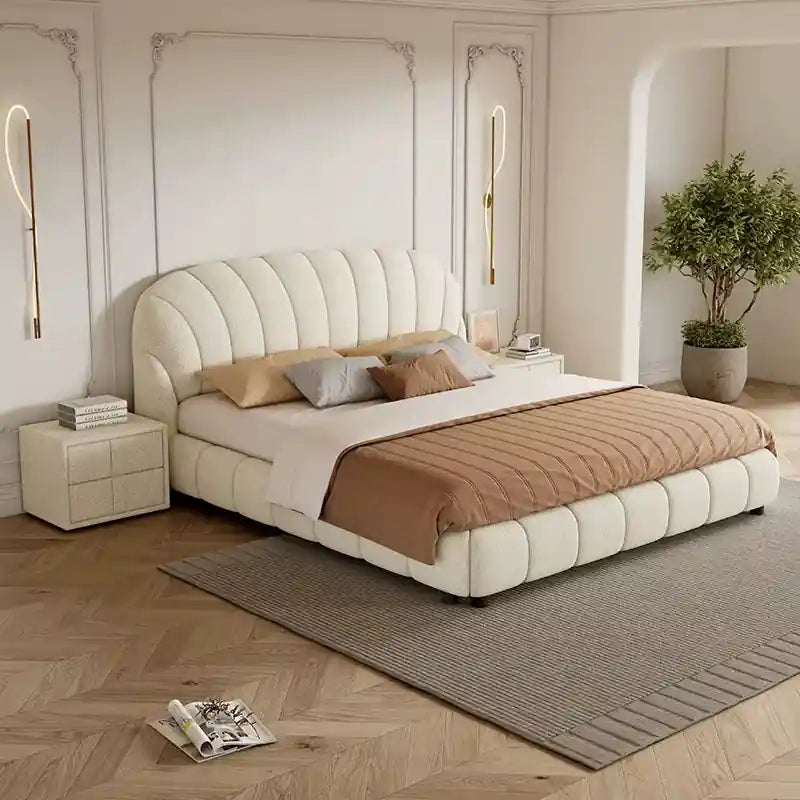 Norel his features a curved shell-inspired headboard with deep vertical; Norel upholstered bed shown as a platform bed.