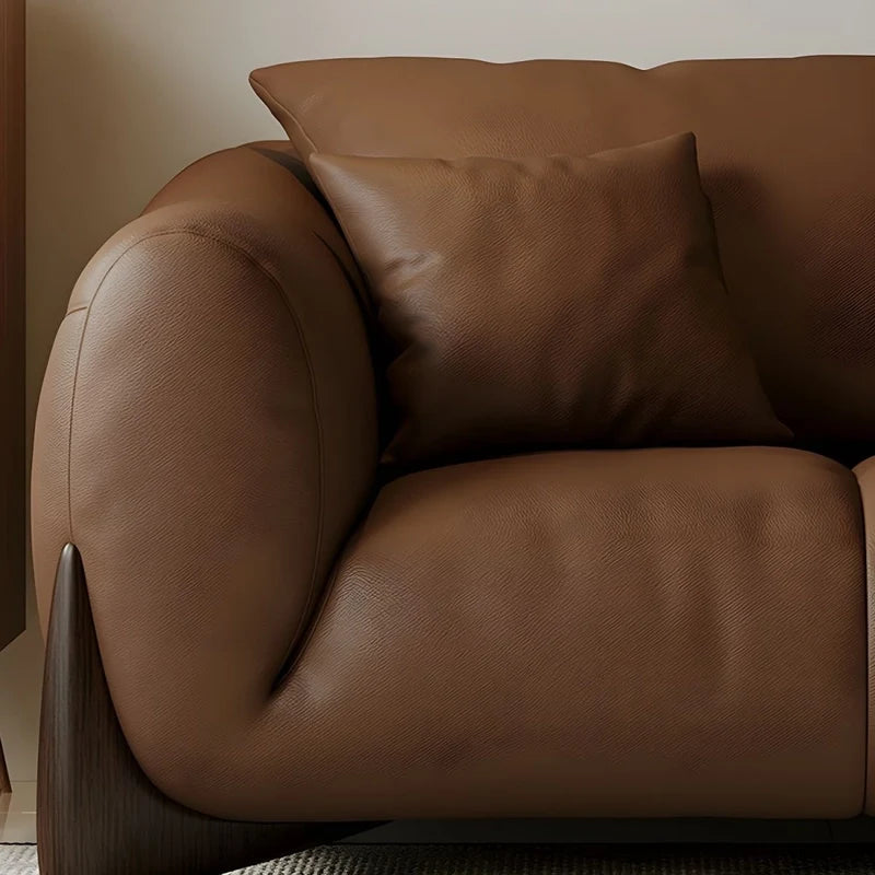 warm brown sofa with deep cushions, soft back support and wide comfortable arms — alternate angle showing the full depth a...